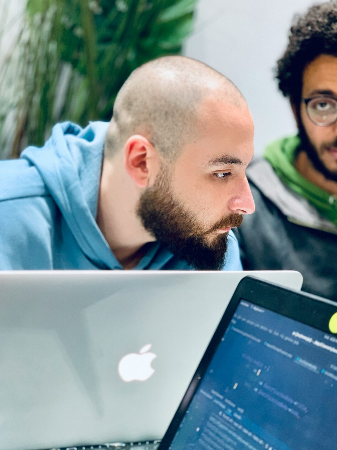 students coding on laptops