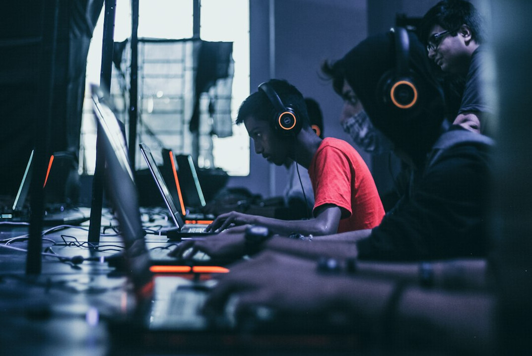 students coding on laptops
