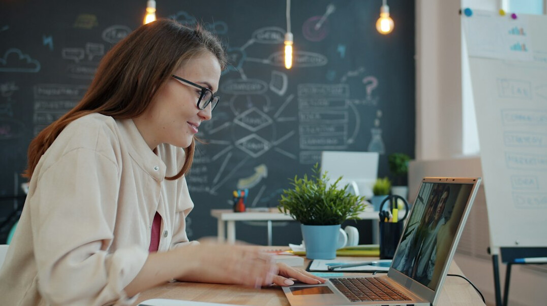 young woman coding at desk
