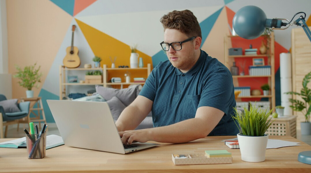 young person coding on laptop