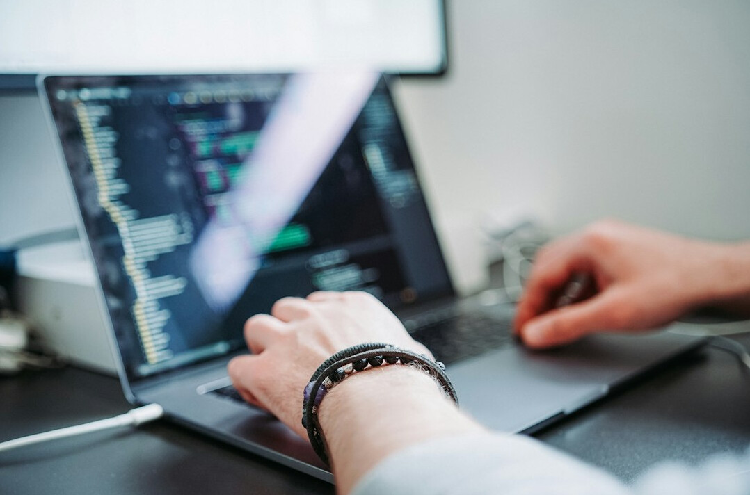 young person coding on laptop